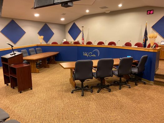 A courtroom setup displaying a table and chairs